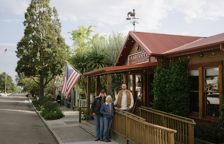 Three members of the Carhartt family standing in front of the Carhartt Family Wines tasting room in Los Olivos, California.